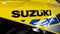 Suzuki yellow motorcycle with large text logo and brand sign on modern motorbike side