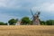 Svaneke, Bornholm / Denmark - July 29 2019: Wind mill at a Farm with a field infront