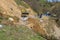 Svaneti, Georgia - 05 May, 2021: The tractor clears the road from a landslide