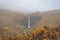 Svartifoss waterfall black basalt columns between autumn colored landscape in fog