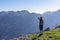 Sveti Ilija - Rear view of woman with backpack looking at scenic view seen from mountain peak Sveti Ilija, Montenegro