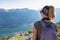 Sveti Ilija - Rear view of woman with backpack looking at scenic view seen from mountain peak Sveti Ilija, Montenegro
