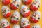 Sveti Vlas, Bulgaria - June 26, 2023: Kinder Surprise Eggs on orange background, flat lay