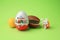 Sveti Vlas, Bulgaria - June 29, 2023: Kinder Surprise Eggs, plastic capsule and toy bunny on light green background
