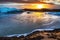 The Svinafellsjokul glacier in Iceland and frozen glacial lagoon at sunset. The low sun is shining on the bank, making the ice