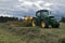 Svitavy, Czech Republic - 20.4.2019: Forage harvest. John Deere tractor rows clover with ROC RT 1000 crawler rake. Agricultural