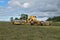 Svitavy, Czech Republic - 20.4.2019: Forage harvest. John Deere tractor rows clover with ROC RT 1000 crawler rake. Agricultural