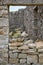 Swaledale sheep, (Ovis aries) resting in the ruins of Surrender lead smelt mill. North Yorkshire. England.