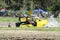 Swamp buggy digging out of mudhole