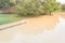 Swamped pathway with fence near riverside neighborhood flood