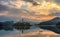 Swan sails along the lake Bled at dawn