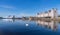 a swan swiming the sea with cityscape of oslo taken at opera house