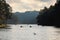 swan swimming and Silhouette group of tourists are rafting in morning sunlight at reservoir Pang Ung landmark mea hong son