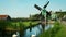 Swans in canal at windmills at Zaanse Schans in Holland. Zaandam, Netherlands
