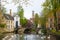 Swans in lake of love in Bruges, channel panoramic view near Begijnhof