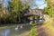 Swans passing under a bridge on the Grand Union canal approaching Debdale Wharf, UK