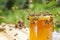 Swarm of bees around a jar full of honey