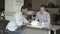 Swarthy guy signs a documents about buying a car in car showroom