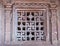 Swastikas in window screen at Durga Gudi under blue cloudscape  Aihole  Karnataka  India