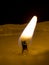 The swaying tongue of a candle flame in a dark space close-up