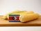 Swaziland flag on a wooden panel with corn isolated on a white b