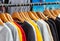 Sweatshirts on hangers in sports store close-up, clothing concept