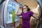 Sweaty woman drinking water seen from inside the fridge