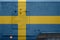 Sweden flag depicted on side part of military armored truck closeup. Army forces conceptual background