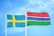 Sweden and Gambia two flags on flagpoles and blue sky