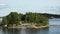 Sweden. Idyllic Stockholm archipelago style. Amazing Swedish Wooden Log Cabin House On Rocky Island. Traditional red