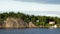 Sweden. Idyllic Stockholm archipelago style. Amazing Swedish Wooden Log Cabin House On Rocky Island. Traditional red