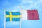 Sweden and Qatar two flags on flagpoles and blue sky