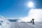 Are, Sweden â€“ March 11, 2019: Two skiers walk down with the skis on the men on top of Areskutan on a sunny day with low clouds