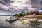 Swedish Archipelago - June 23, 2018: Boat docked in a small town in the Swedish Archipelago during Midsummer, Sweden