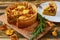 Swedish cheese and mushroom pie - quiche on the kitchen table decorated with rosemary. Sliced vegetarian chanterelles tart