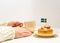 Swedish cinnamon buns kanelbullar and coffee cup in hand on the white wooden table. Swedish flags. Coffee break fika