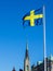 Swedish flag with a church in the background