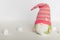 Swedish gnome in green clothes and pink hat on a white background