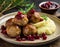 Swedish meatballs with mashed potatoes and red lingonberry sauce. Wooden table. Swedish cuisine