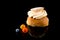 Swedish Semla with colorful balls isolated on black background with reflections, copy space