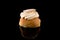 Swedish Semla isolated on black background with reflections, centered