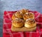 Swedish twisted cinnamon rolls sprinkled with pearl sugar on a wooden board