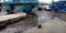 Sweeper cleaning bus stand floor, bus parking around dirty place