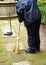 Sweeper in the street sweeping up with her broom