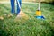 Sweeping leaves with orange rake