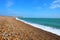 Sweeping shoreline of Seaford Beach in the sun