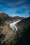 A sweeping view framed by trees in the foreground of the head of the majestic Salmon Glacier in British Columbia, Canada,