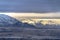 Sweeping view of Salt Lake City bordered by towering sunlit snowy mountain