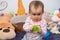 Sweet 1 year old baby girl portrait with rubber chew toy in her room