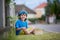 Sweet adorable little child, boy eating strawberries, summertime